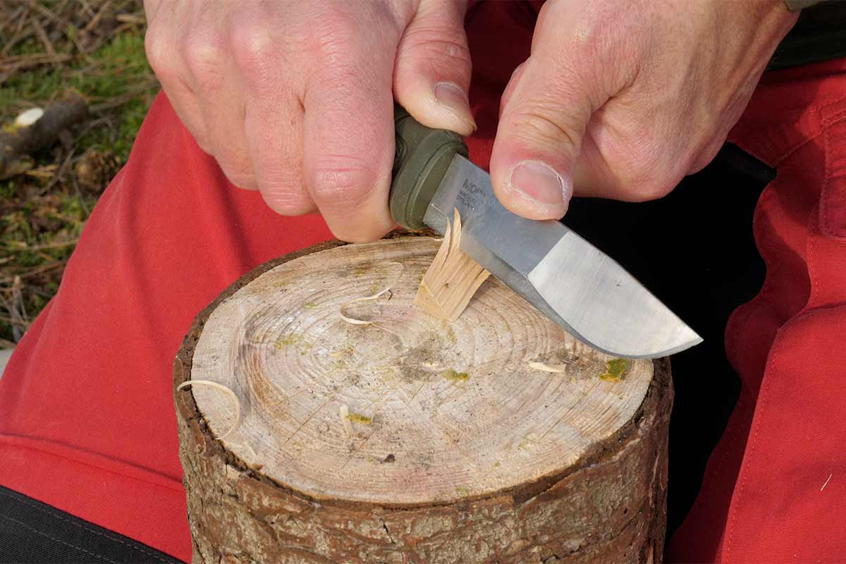 The Morakniv Kansbals handle has a nice 'guard' to prevent the thumb slipping on the blade.