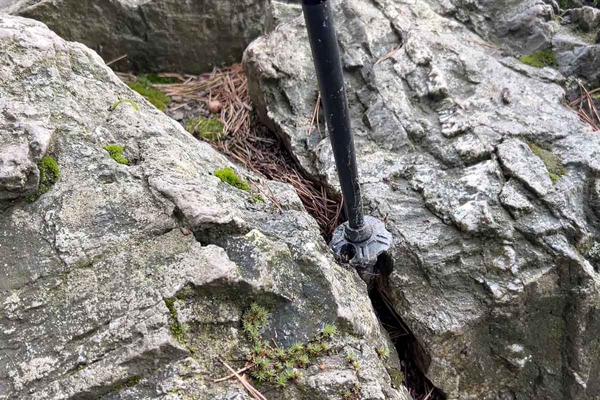 The tip is mounted on a flexible base. If it gets caught in a crack or wedged between rocks, the tip bends instead of breaking the pole.