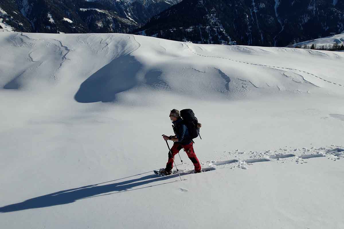 Exchanging the small basket is needed when snowshoe walking in Val Lumnezia.